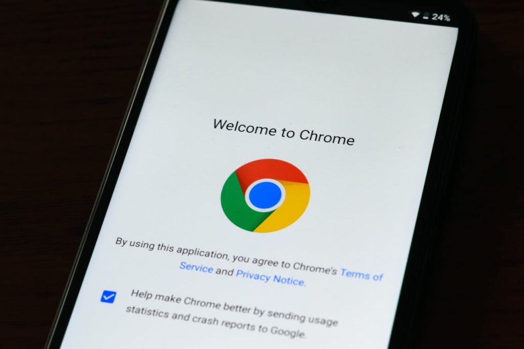 Close-up of smartphone displaying Google Chrome's welcome page and logo.